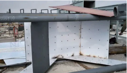 Light-coloured lining panels with fixing holes inside a steel hopper