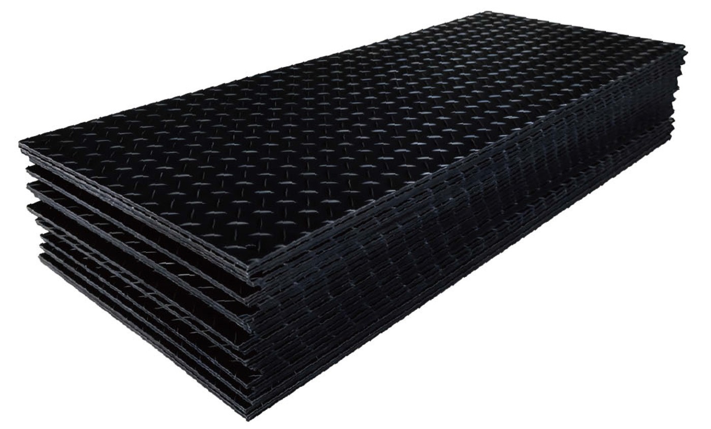 Stacked black ground protection mats with a textured tread